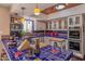 The kitchen features custom blue tile countertops, white cabinets, stainless appliances and a butcher block island at 7302 E Rose Ln, Scottsdale, AZ 85250