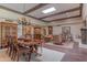 Open-concept living and dining area with wood floors, exposed beams, and decorative accents at 7302 E Rose Ln, Scottsdale, AZ 85250