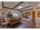 Spacious living room with a fireplace, wood floors, and skylight at 7302 E Rose Ln, Scottsdale, AZ 85250