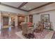 Living room showcasing decorative furniture, wood floors, and a rustic wood door at 7302 E Rose Ln, Scottsdale, AZ 85250