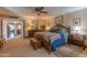 Spacious main bedroom offers a ceiling fan, bedside tables and access to the rest of the house at 7302 E Rose Ln, Scottsdale, AZ 85250