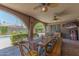 Inviting outdoor patio with an extra long wooden dining table overlooking the beautiful backyard at 7302 E Rose Ln, Scottsdale, AZ 85250