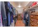 Functional walk-in closet with ample hanging space, built-in shelves, and storage solutions at 7302 E Rose Ln, Scottsdale, AZ 85250