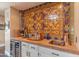 Close-up of the wet bar area, showcasing decorative tile backsplash and wine storage at 7302 E Rose Ln, Scottsdale, AZ 85250