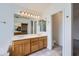 Well-lit bathroom featuring a double sink vanity and large mirror at 7344 E Flower Ave, Mesa, AZ 85208