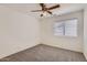 Bright bedroom with neutral carpet, ceiling fan and a bright window at 7344 E Flower Ave, Mesa, AZ 85208