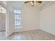 Tile floor bedroom with bright window and ceiling fan at 7344 E Flower Ave, Mesa, AZ 85208