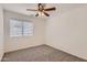 Cozy bedroom with neutral carpet, ceiling fan and a bright window at 7344 E Flower Ave, Mesa, AZ 85208