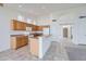 Bright kitchen features classic wood cabinets, tile flooring, and a functional breakfast bar at 7344 E Flower Ave, Mesa, AZ 85208