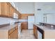 Well-lit kitchen featuring stainless steel appliances, tile flooring, and ample counter space at 7344 E Flower Ave, Mesa, AZ 85208