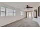 Open living room with large windows, neutral carpet and easy patio access at 7344 E Flower Ave, Mesa, AZ 85208