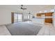 Spacious open-concept living room with access to the kitchen and sliding doors to the backyard at 7344 E Flower Ave, Mesa, AZ 85208