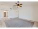 Spacious living room with neutral carpet and tile flooring, perfect for gathering and relaxation at 7344 E Flower Ave, Mesa, AZ 85208