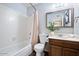 Clean bathroom features a shower-tub combination, a toilet, and a vanity with a large framed mirror at 811 E Eugie Ave, Phoenix, AZ 85022