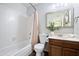Clean bathroom featuring a shower-tub combo, neutral color, and decorative mirror at 811 E Eugie Ave, Phoenix, AZ 85022