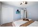 Serene bedroom with sliding closet doors, a ceiling fan, and cozy neutral tones at 811 E Eugie Ave, Phoenix, AZ 85022