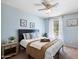 Serene bedroom boasts soft blue walls, a ceiling fan, and a window overlooking a peaceful outdoor view at 811 E Eugie Ave, Phoenix, AZ 85022