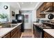 Efficient kitchen with modern appliances, updated countertops, and wooden cabinets, offering ample storage at 811 E Eugie Ave, Phoenix, AZ 85022
