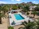 Inviting community pool offers a refreshing escape with ample seating and mountain views at 811 E Eugie Ave, Phoenix, AZ 85022
