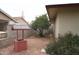 Charming backyard with decorative well, gravel ground cover, and a mature orange tree at 8334 N 55Th Ave, Glendale, AZ 85302