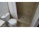 This bathroom offers a toilet and a shower with neutral tiling and a shower curtain at 8334 N 55Th Ave, Glendale, AZ 85302