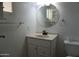 This beautiful bathroom features a vanity, round mirror, and ample cabinet space at 8334 N 55Th Ave, Glendale, AZ 85302