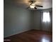 Bedroom with hardwood floors, neutral paint, ceiling fan and natural light at 8334 N 55Th Ave, Glendale, AZ 85302