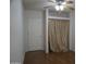 Bedroom featuring wood floor, ceiling fan, a closet with a curtain, and a door at 8334 N 55Th Ave, Glendale, AZ 85302