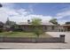 Traditional home with desert landscaping, long driveway, and block wall for added curb appeal at 8334 N 55Th Ave, Glendale, AZ 85302