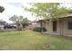 Well-maintained front yard featuring healthy green grass, mature trees and a charming wishing well at 8334 N 55Th Ave, Glendale, AZ 85302
