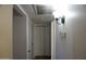 Hallway with white walls, wood floors, closet and light fixture at 8334 N 55Th Ave, Glendale, AZ 85302