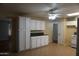 Well-maintained kitchen featuring white cabinets, neutral paint, tile flooring, and standard appliances at 8334 N 55Th Ave, Glendale, AZ 85302