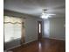 Inviting living room features hardwood floors, a ceiling fan and a window with charming valance at 8334 N 55Th Ave, Glendale, AZ 85302