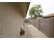A view down the side yard between the home and a block fence at 8334 N 55Th Ave, Glendale, AZ 85302