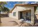 Outdoor dining area in backyard with desert landscaping, lighting, and block fence at 897 E Cherry Hills Dr, Chandler, AZ 85249