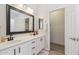 Bright bathroom features double sinks, granite counters, framed mirror, and a walk-in closet at 897 E Cherry Hills Dr, Chandler, AZ 85249