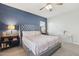 Comfortable bedroom featuring a bed with a tufted headboard, side tables, and a colorful accent wall at 897 E Cherry Hills Dr, Chandler, AZ 85249