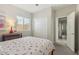 Cozy bedroom with a cherry-patterned bedspread, closet, and a view of the hallway at 897 E Cherry Hills Dr, Chandler, AZ 85249