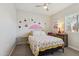 A charming bedroom features a cherry-themed bedspread, a ceiling fan, and plenty of natural light at 897 E Cherry Hills Dr, Chandler, AZ 85249
