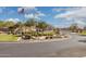 Gated community entrance with American flag, mature trees, and well-maintained landscaping at 897 E Cherry Hills Dr, Chandler, AZ 85249