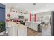 Bright kitchen with white cabinetry, quartz countertops, stainless appliances, and a seamless flow to the dining area at 897 E Cherry Hills Dr, Chandler, AZ 85249