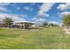 Community playground with covered seating area, grassy field, blue skies and puffy white clouds at 897 E Cherry Hills Dr, Chandler, AZ 85249
