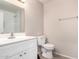 Well-lit bathroom featuring a white vanity, toilet, and shower with white subway tile at 9803 N 40Th Dr, Phoenix, AZ 85051