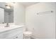 Clean, bright bathroom with white vanity and toilet, subway tile shower and towel bar at 9803 N 40Th Dr, Phoenix, AZ 85051