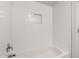 Clean bathtub with white subway tile surround and a built-in niche for storage in an updated bathroom at 9803 N 40Th Dr, Phoenix, AZ 85051