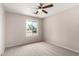 Bedroom featuring a ceiling fan and a window looking out onto the neighborhood at 9803 N 40Th Dr, Phoenix, AZ 85051