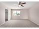 Bright bedroom with neutral walls and carpet, with ceiling fan, closet, and window view at 9803 N 40Th Dr, Phoenix, AZ 85051