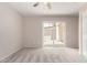 Carpeted bedroom with sliding glass door leading to outdoor space and a ceiling fan at 9803 N 40Th Dr, Phoenix, AZ 85051