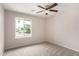 Comfortable bedroom with a ceiling fan, neutral carpet, and a large window at 9803 N 40Th Dr, Phoenix, AZ 85051