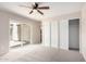 Bright carpeted bedroom with sliding glass doors, closet, and ceiling fan providing comfort and style at 9803 N 40Th Dr, Phoenix, AZ 85051